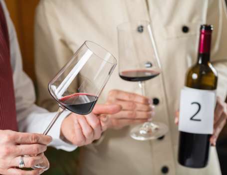 Blind wine tasting, identifying different types of wines. Participants taste and identify different types of wines during a blind tasting, learning to identify the characteristics of various grape varietals.