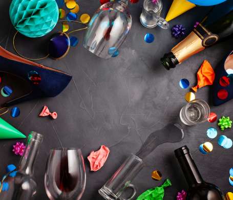 Top view shot of after a party celebration with empty bottles,wine glass, girl shoes and party accessories